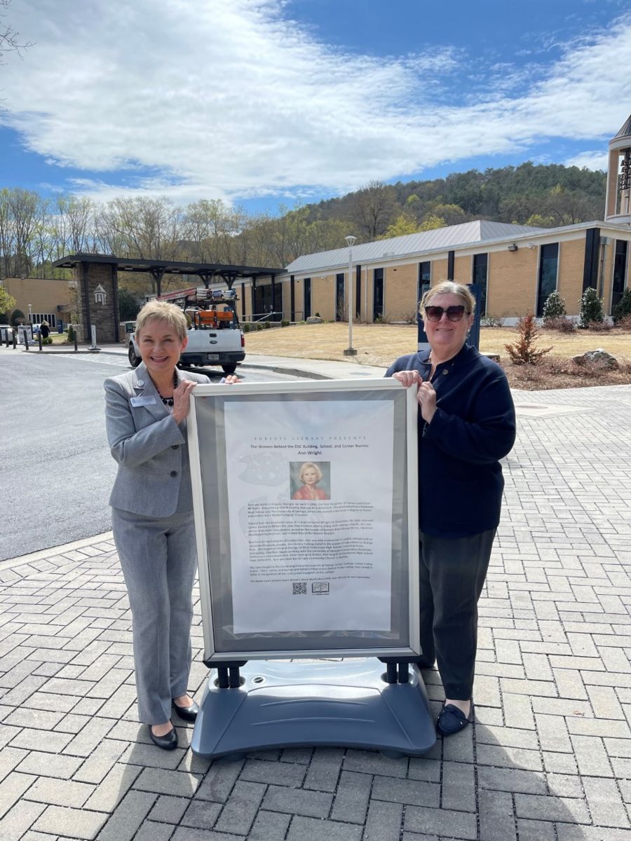Dean Helms and Dr. Connors with an information board of Ann Wright