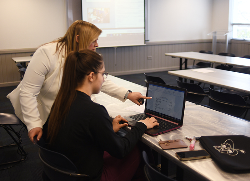 Mallory Safley helping a female student with her resume