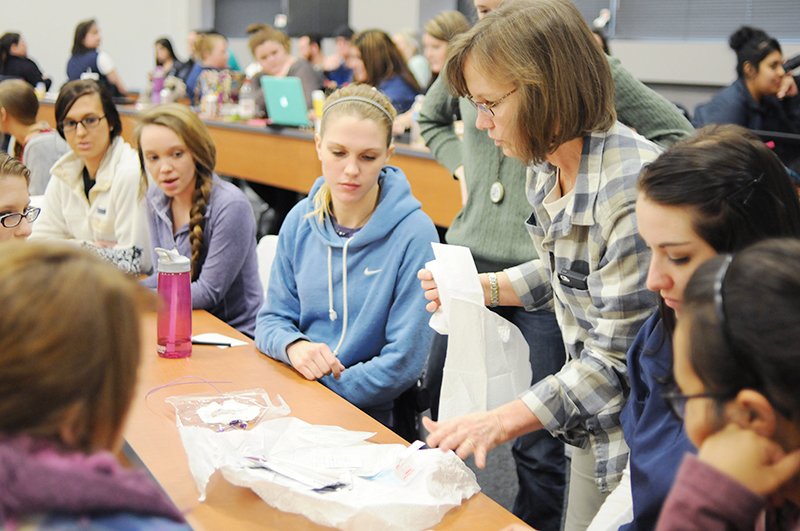 Photo of Deb Richardson working with students in class
