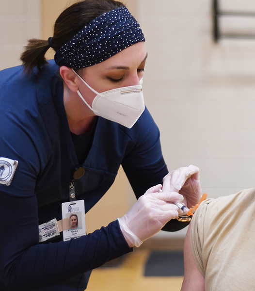 Health worker giving vaccine in clinic