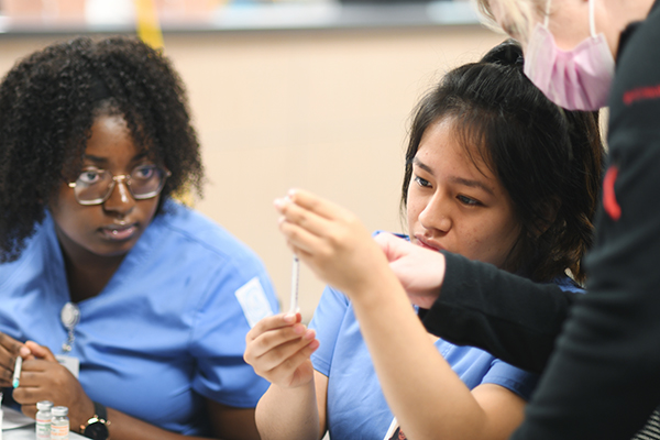 medical students pulling a syringe