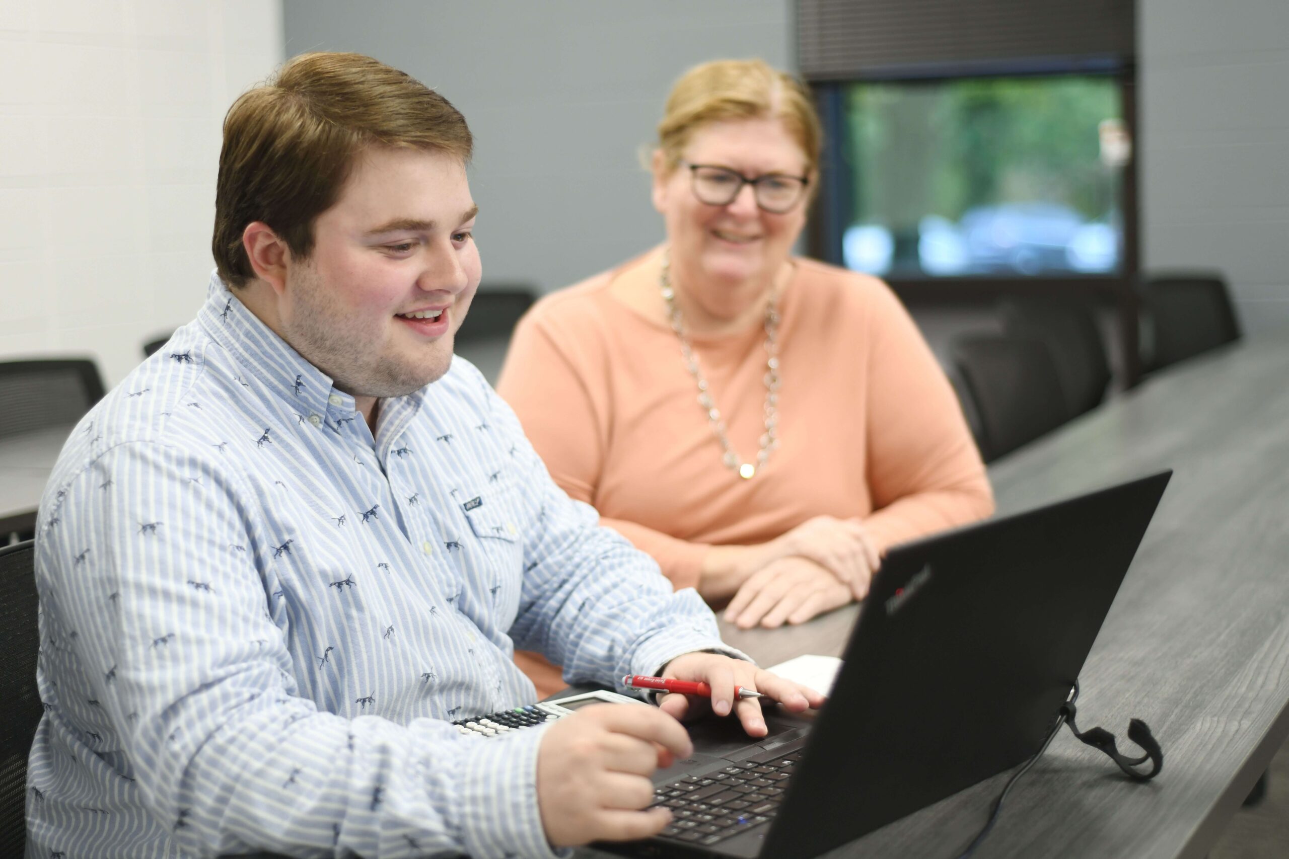 Student on laptop, smiling