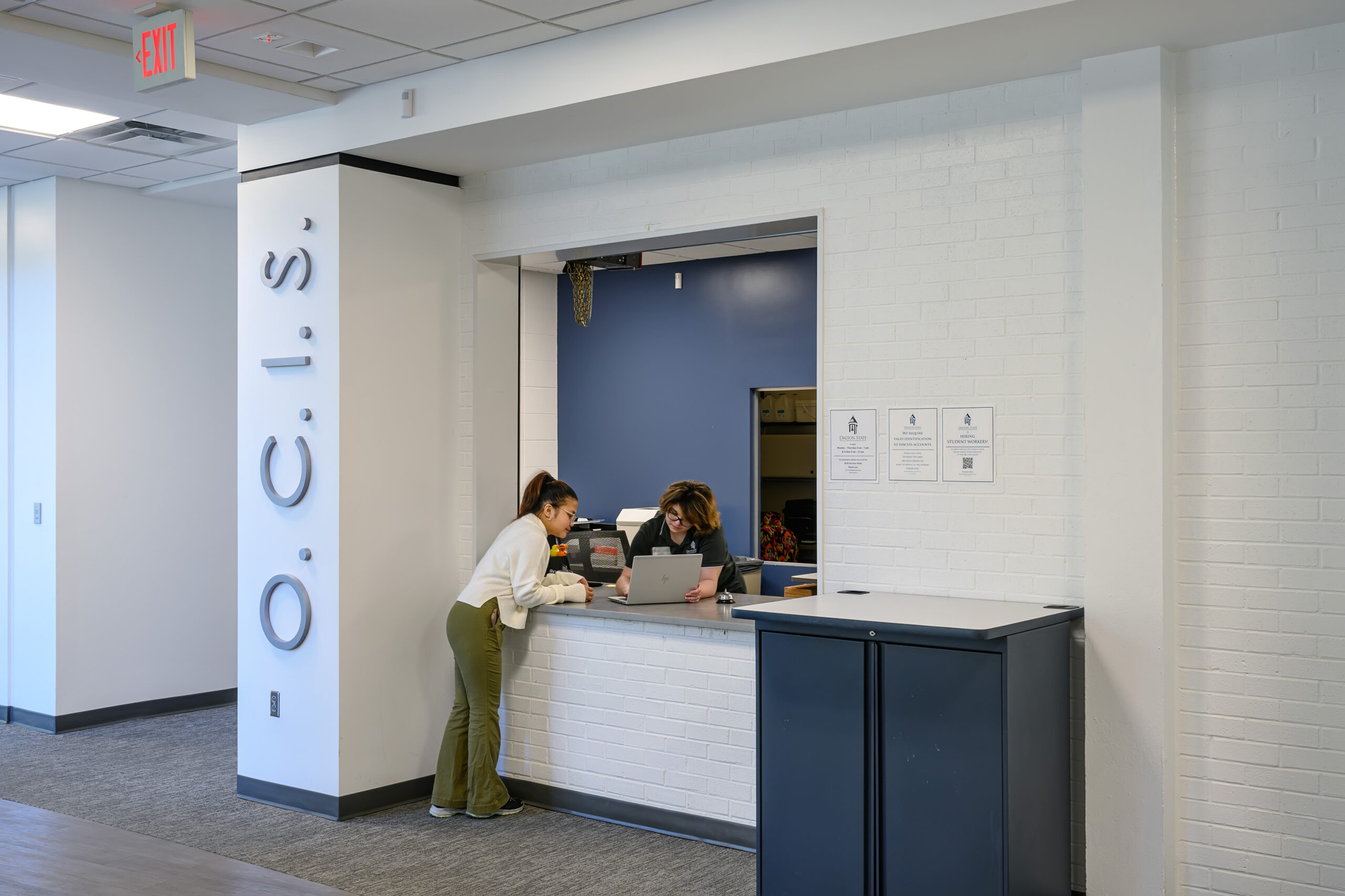 A female students gets assistance at a service counter