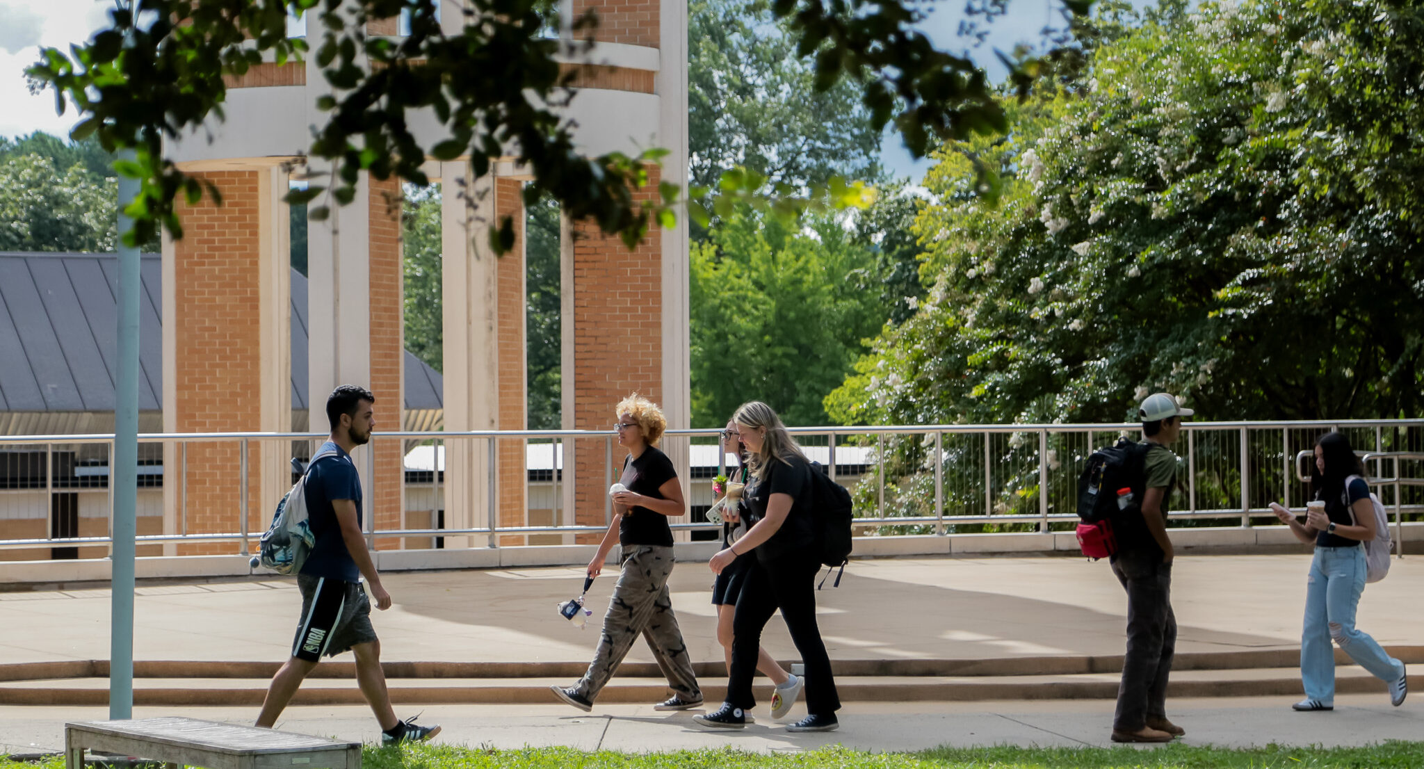 Students walk across Dalton State campus in a small group.
