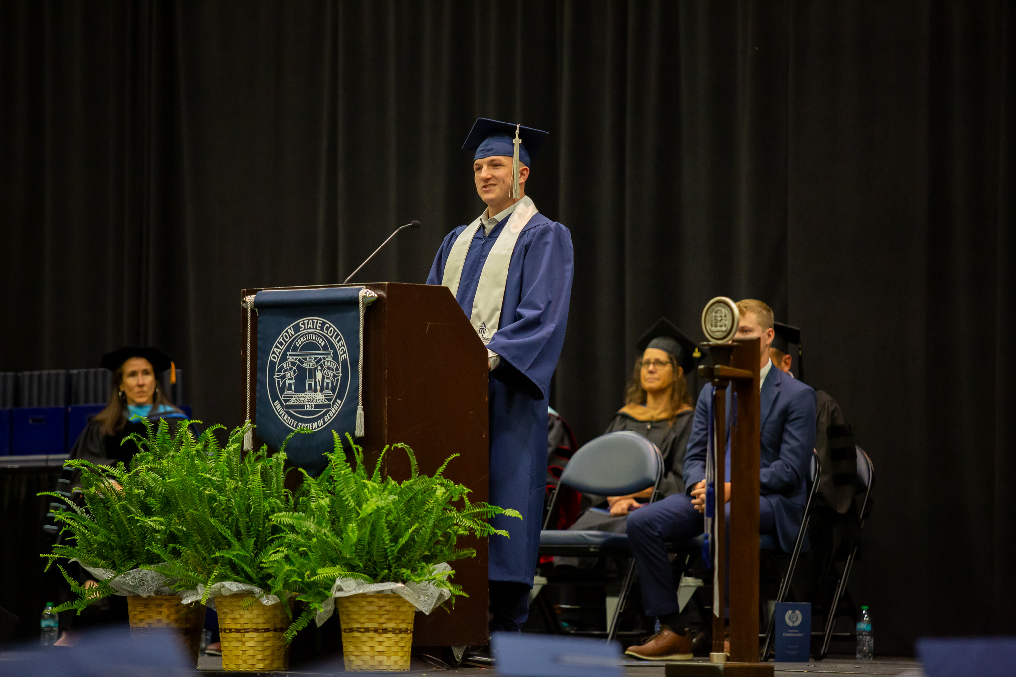 A male graduate speaks a commencement.